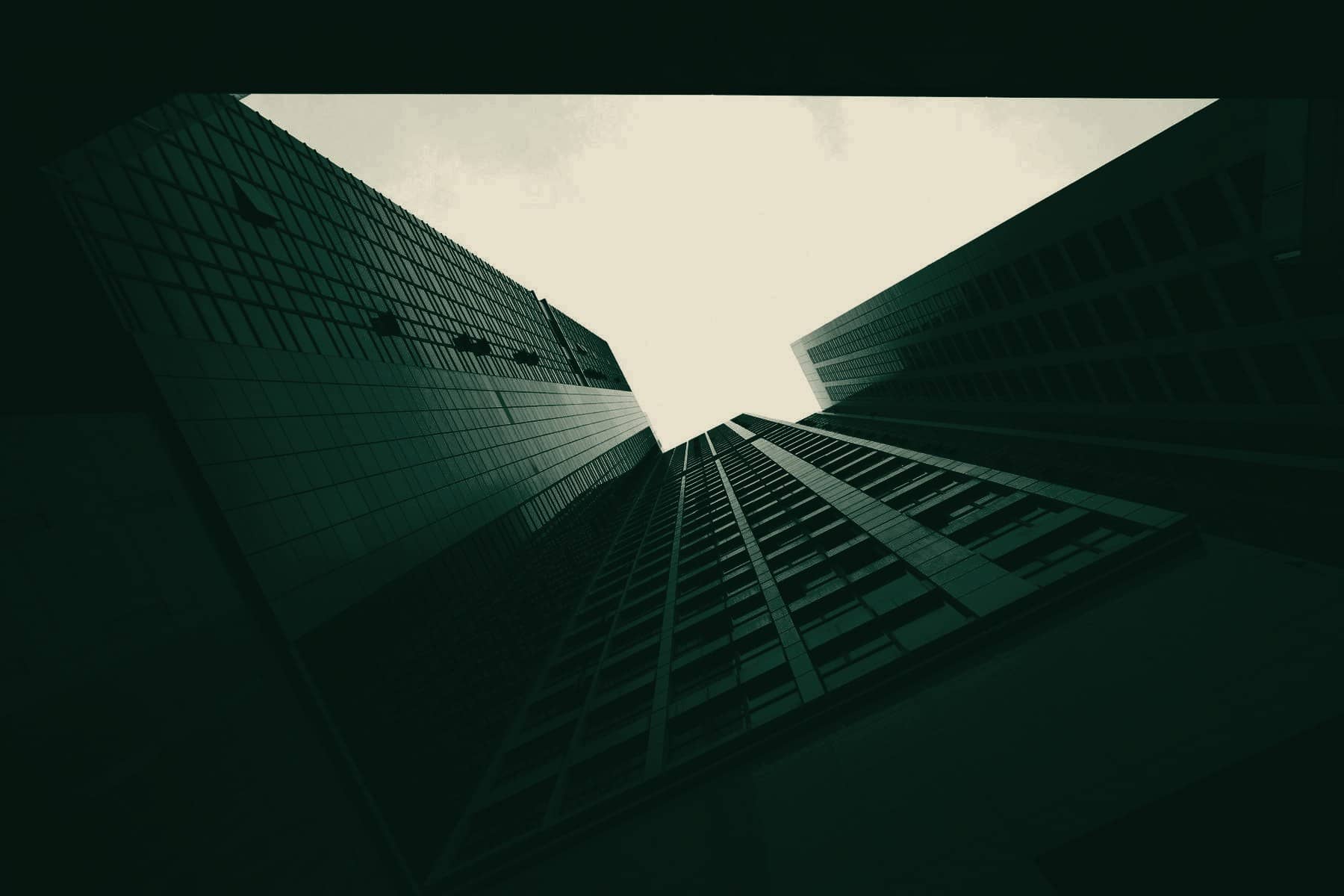 Corporate towers rising against a bright sky