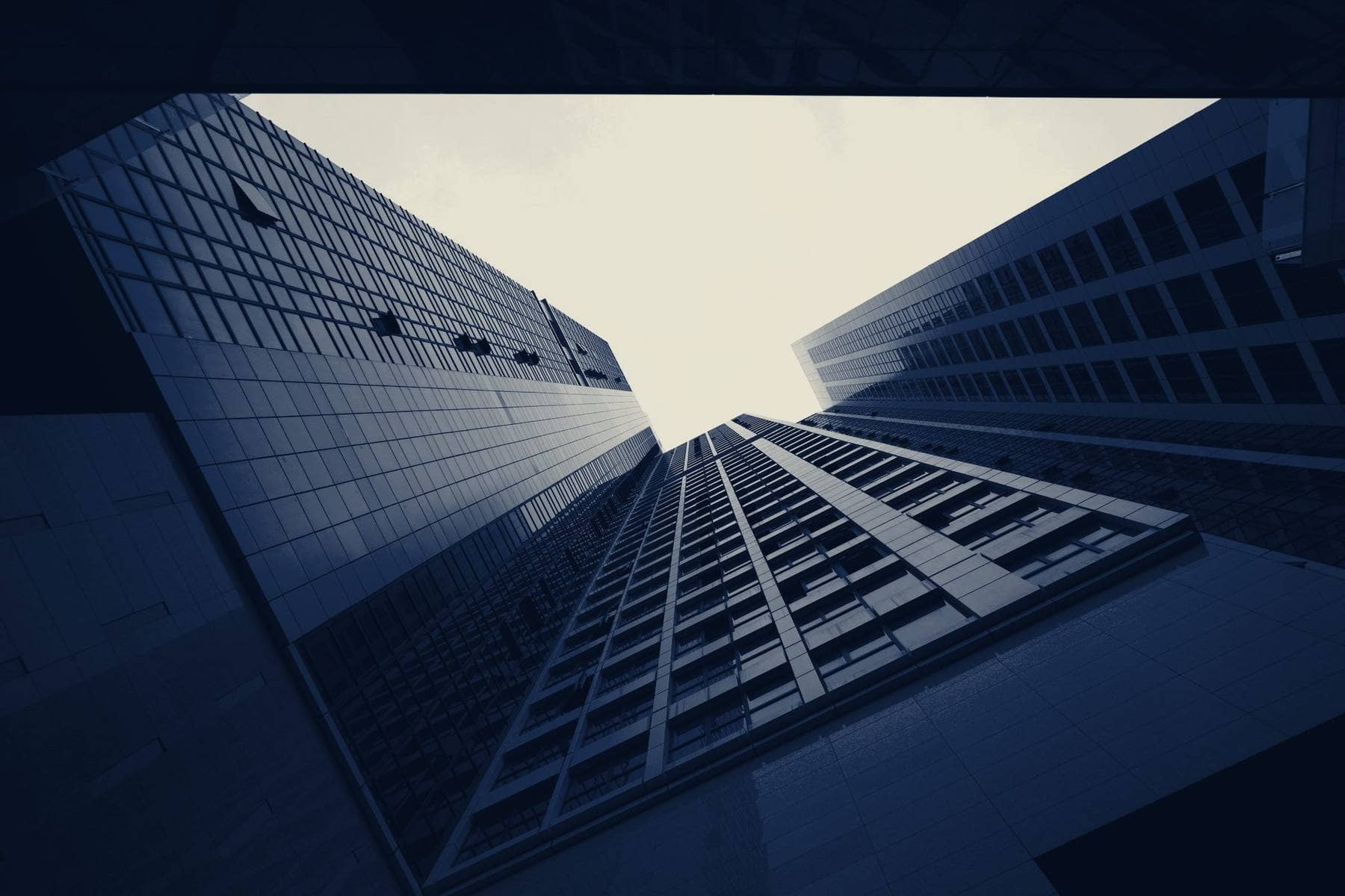 Corporate towers rising against a bright sky